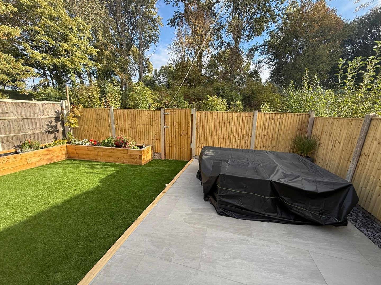 Landscaped Nottingham garden with artificial grass and tiled patio