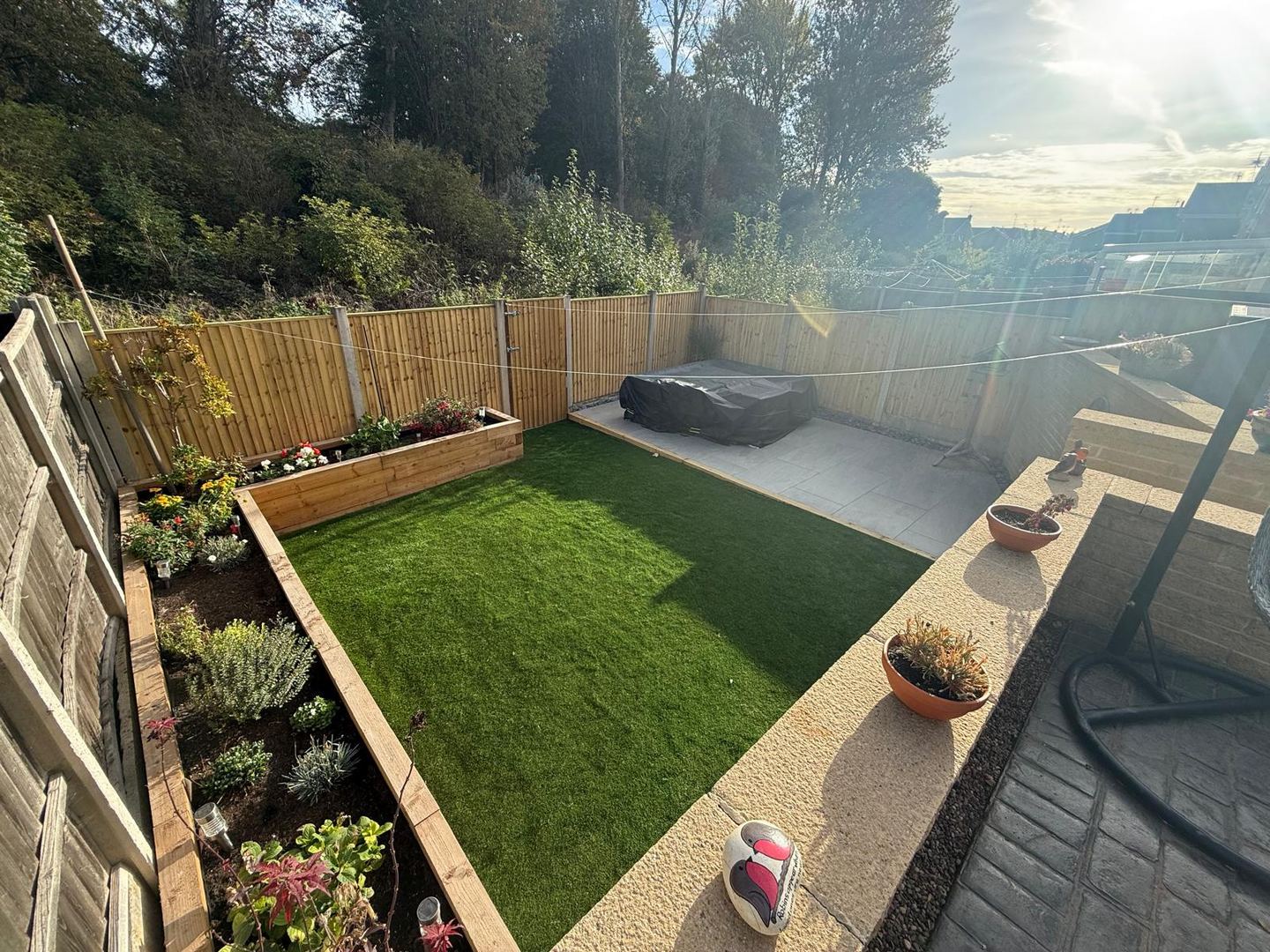Raised timber planters and artificial lawn in a Nottingham garden
