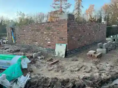 Bricklayers building the garage cavity walls by Hardy and Sons