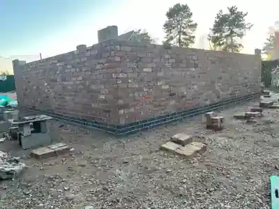 Facing brick walls built around the new garage by Hardy and Sons