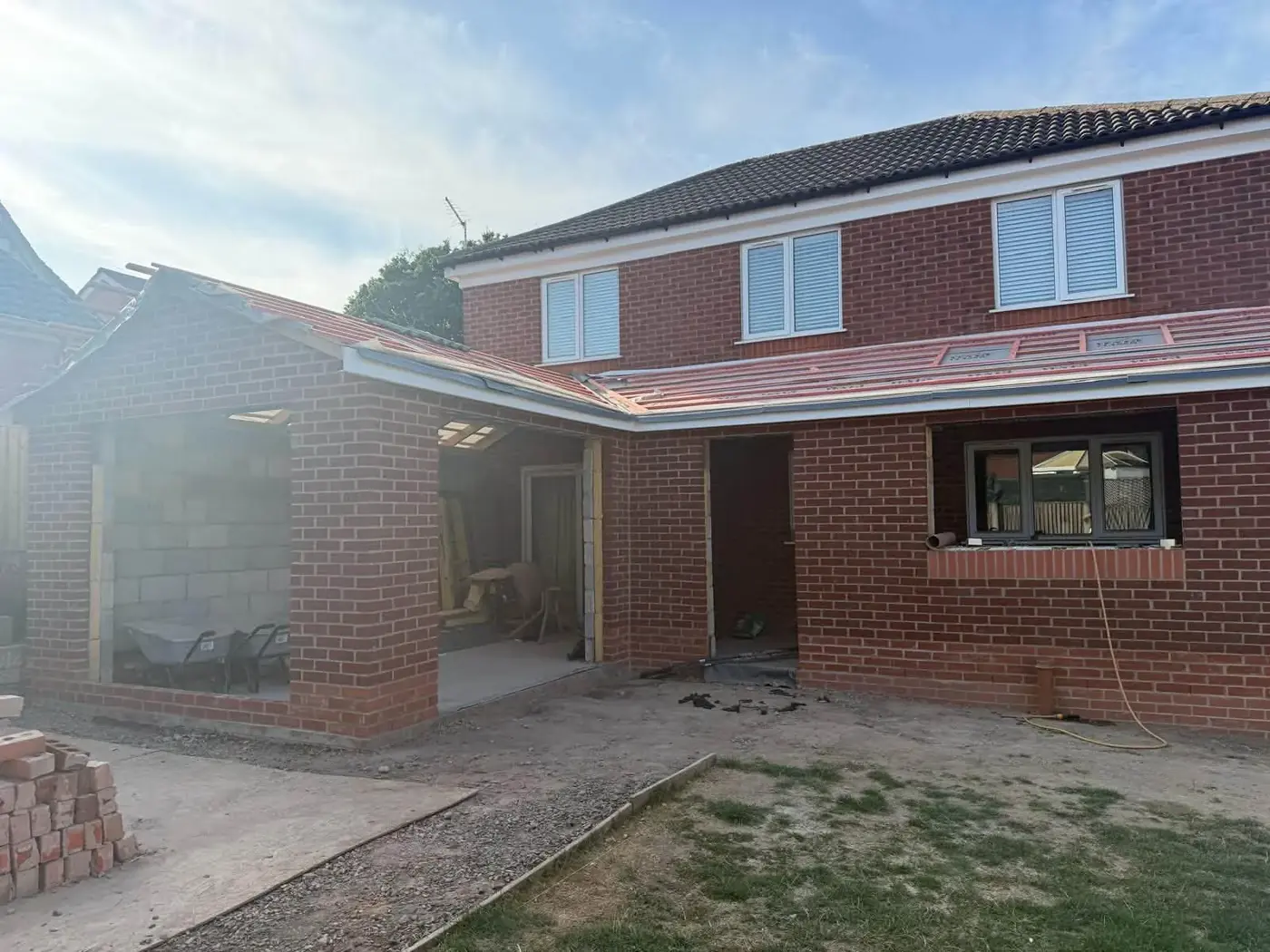 Home extension exterior with new brickwork and roof structure by Hardy and Sons