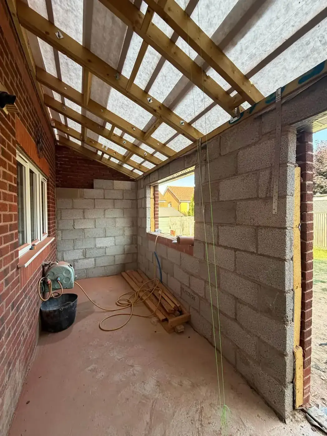 Interior of home extension showing new blockwork and timber roof structure
