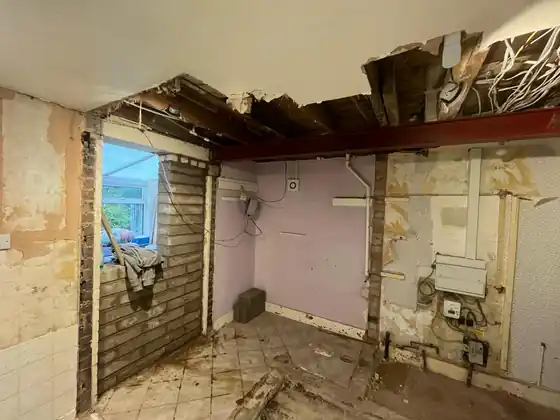 Internal walls opened and structural steel beams installed at ceiling level