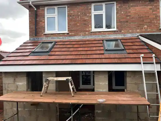 Tiled kitchen extension roof with two roof windows installed