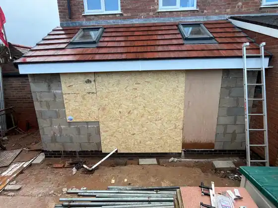 Kitchen extension roof completed before the windows and render finish